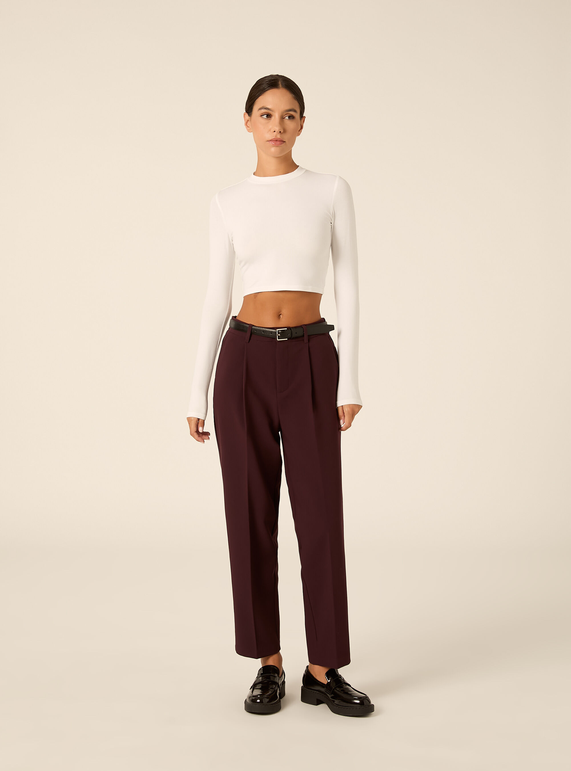 Tapered tailored trousers with pleats and belt
