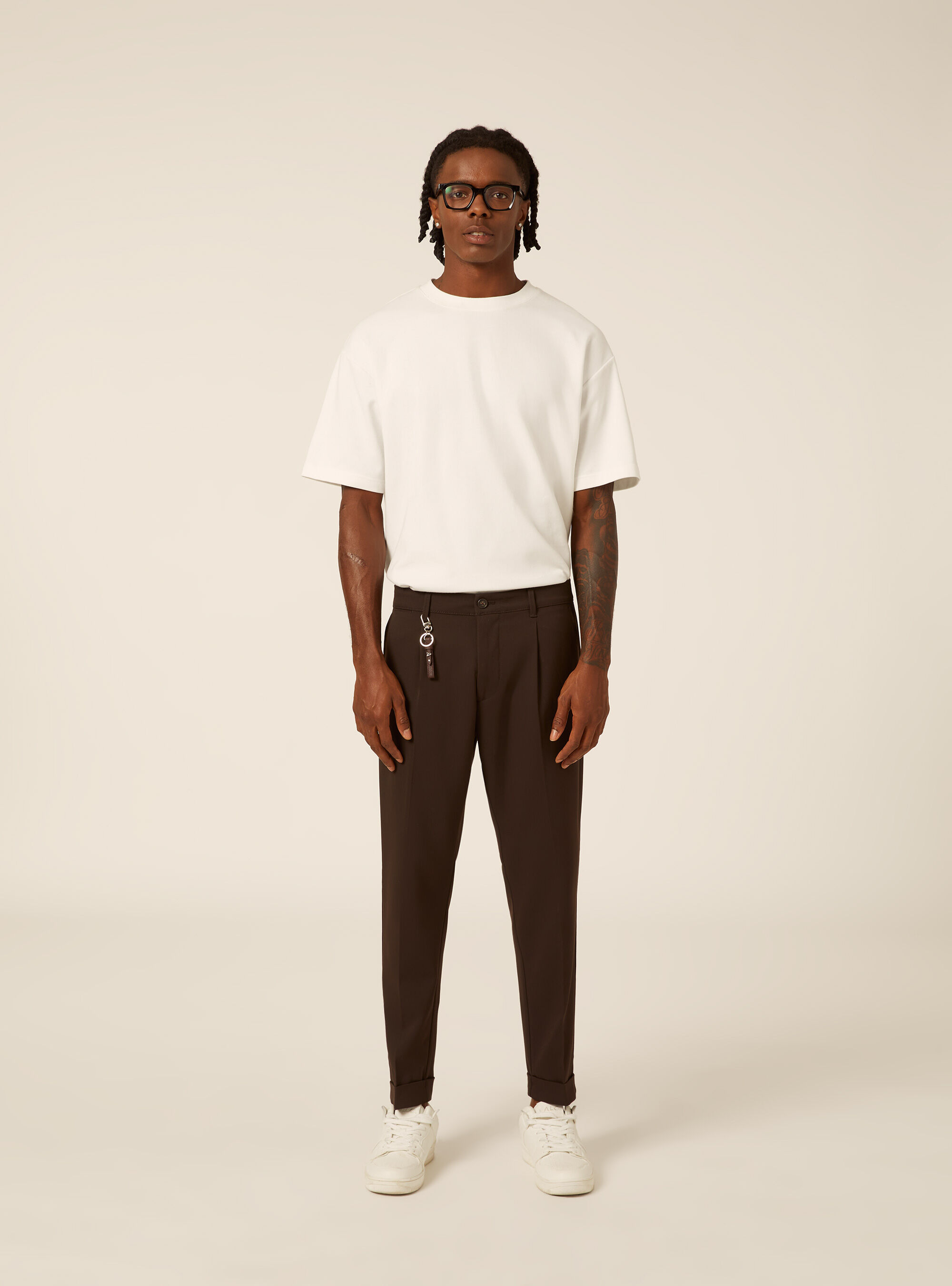 Tailored trousers with pleats and charm detail