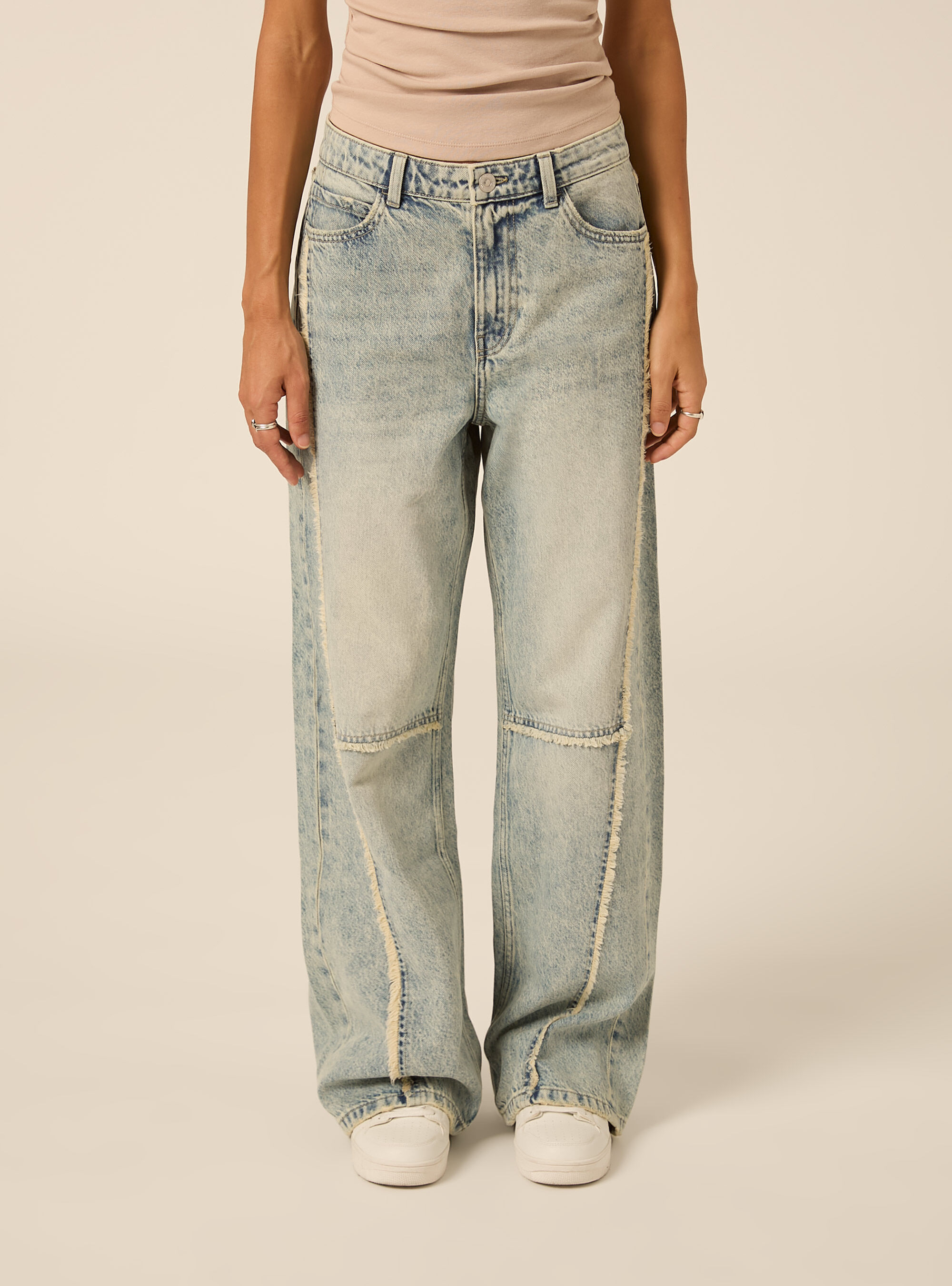 Wide leg baggy jeans with exposed seams and frayed details