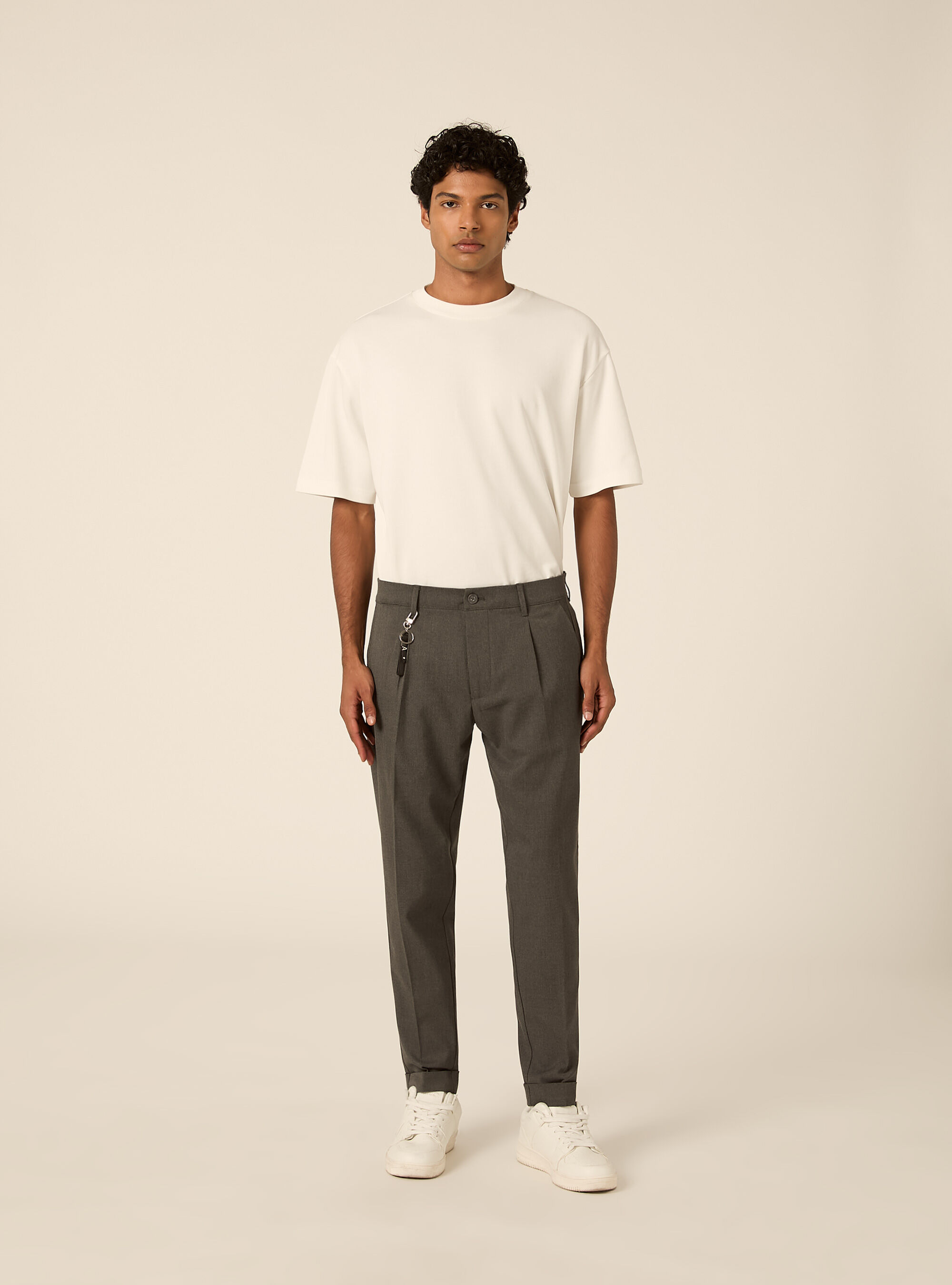 Tailored trousers with pleats and charm detail