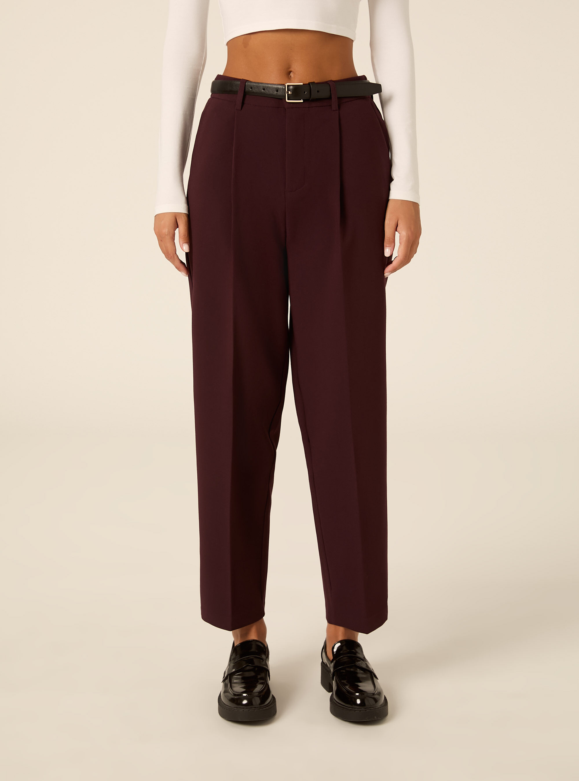 Tapered tailored trousers with pleats and belt