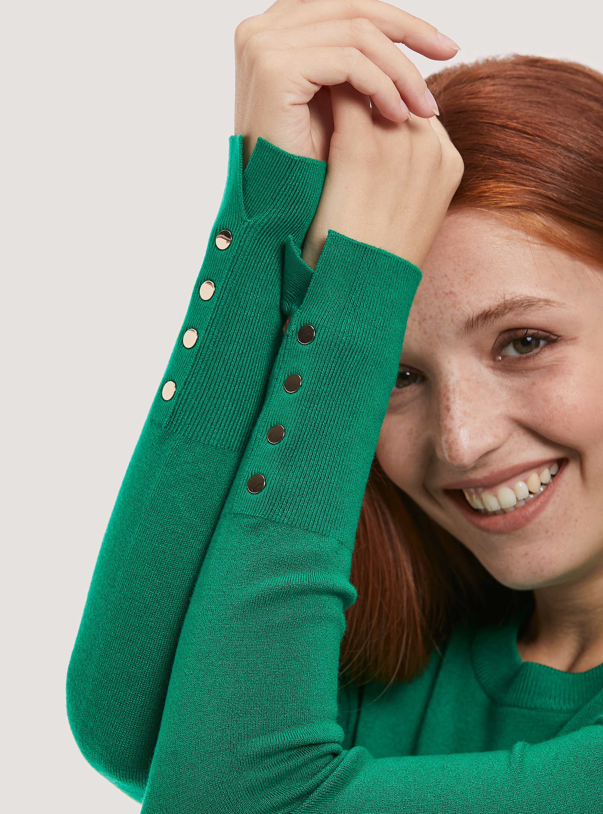 Round neck pullover with buttons on sleeve