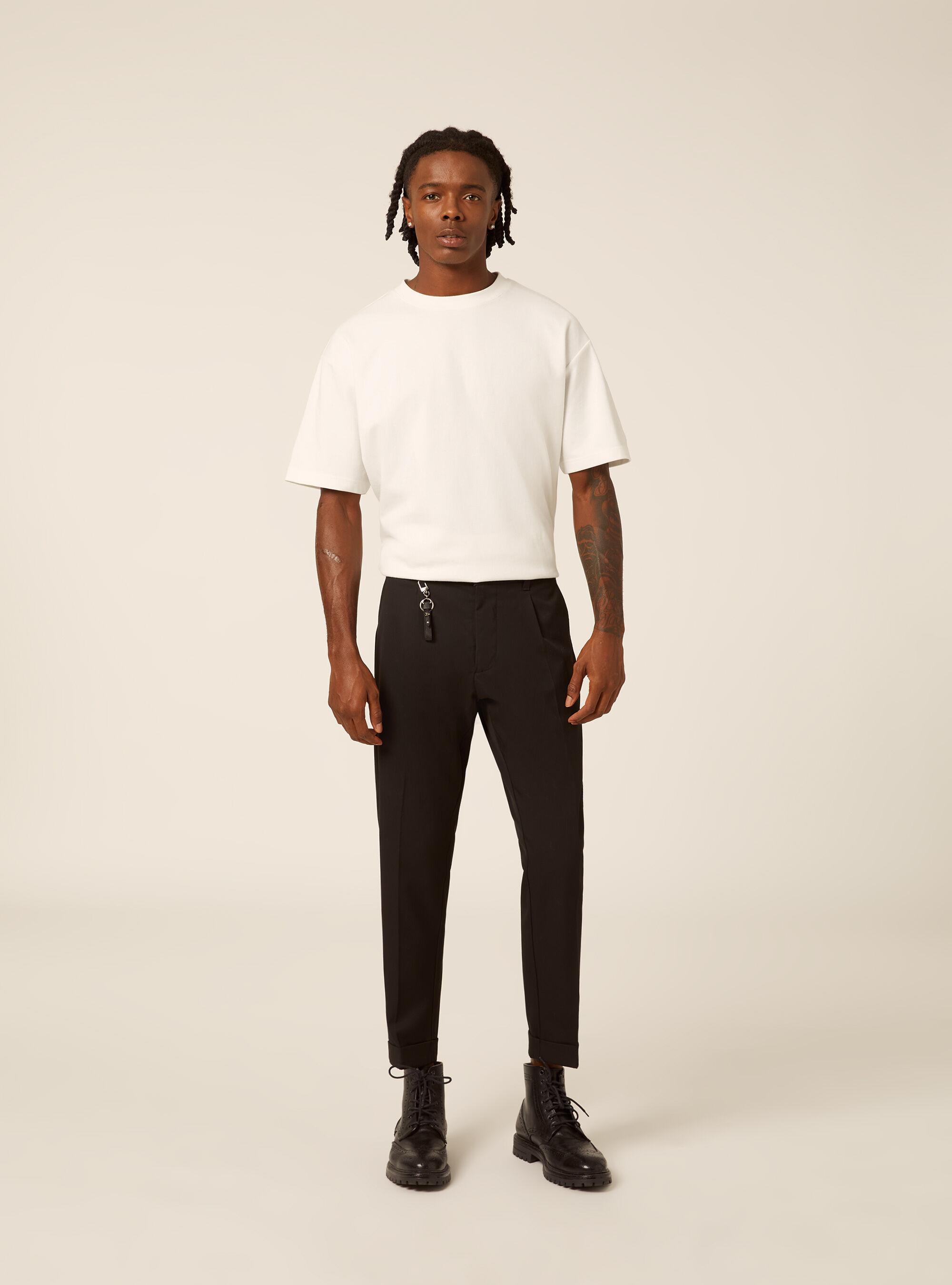 Tailored trousers with pleats and charm detail