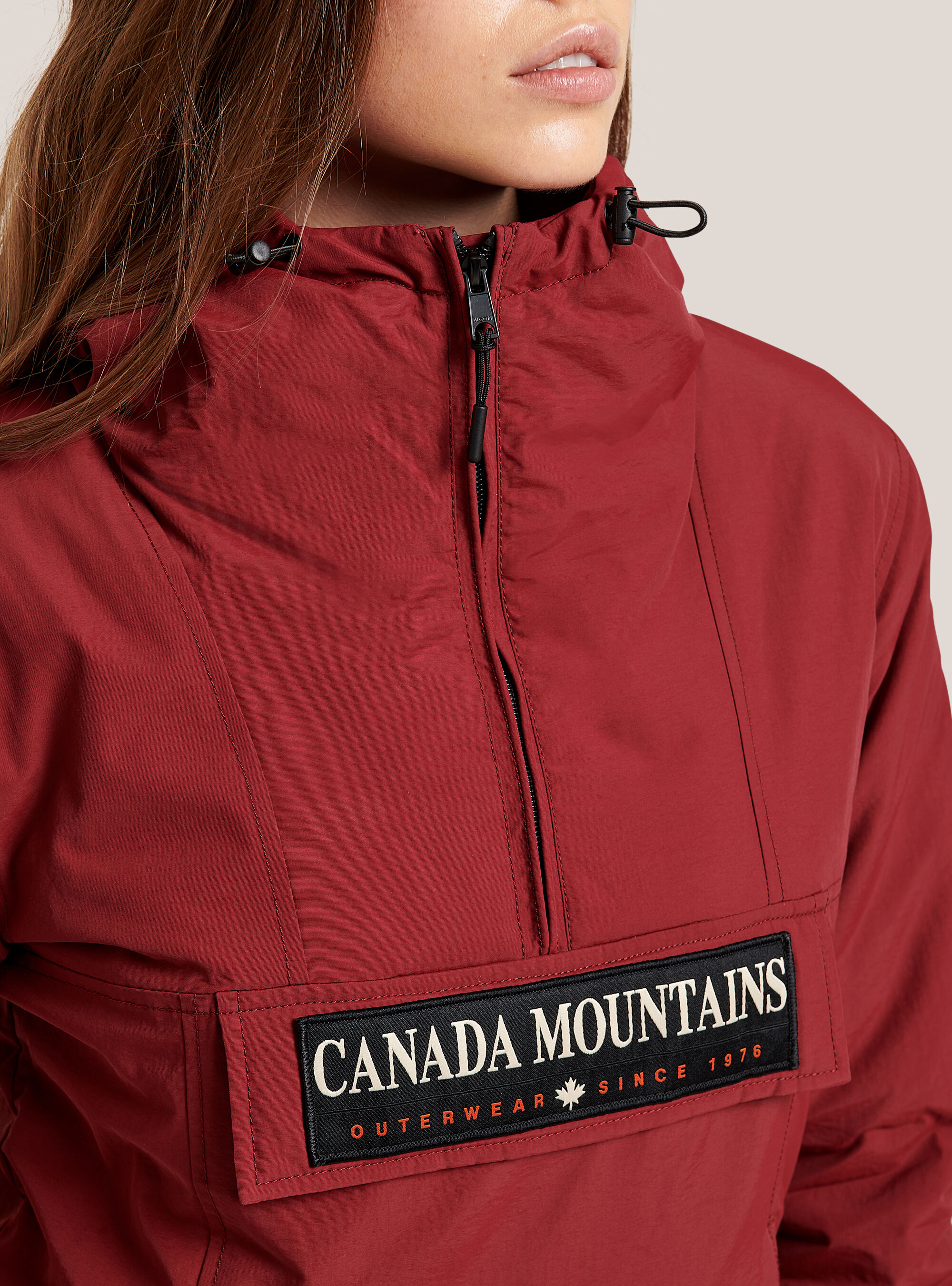 Anorak jacket with front flap with patch and hood