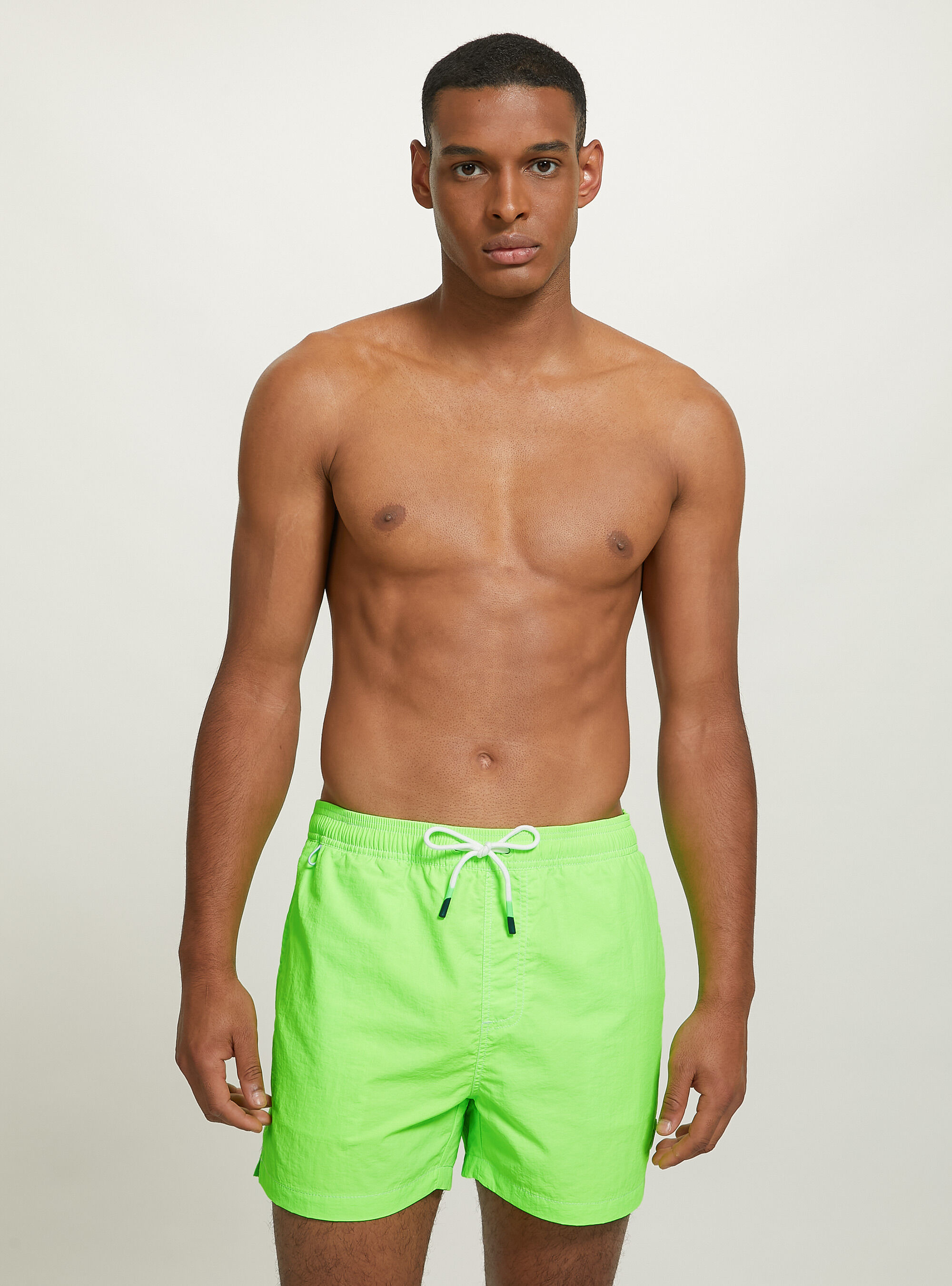 Plain coloured swimming costume with embroidery and back pocket