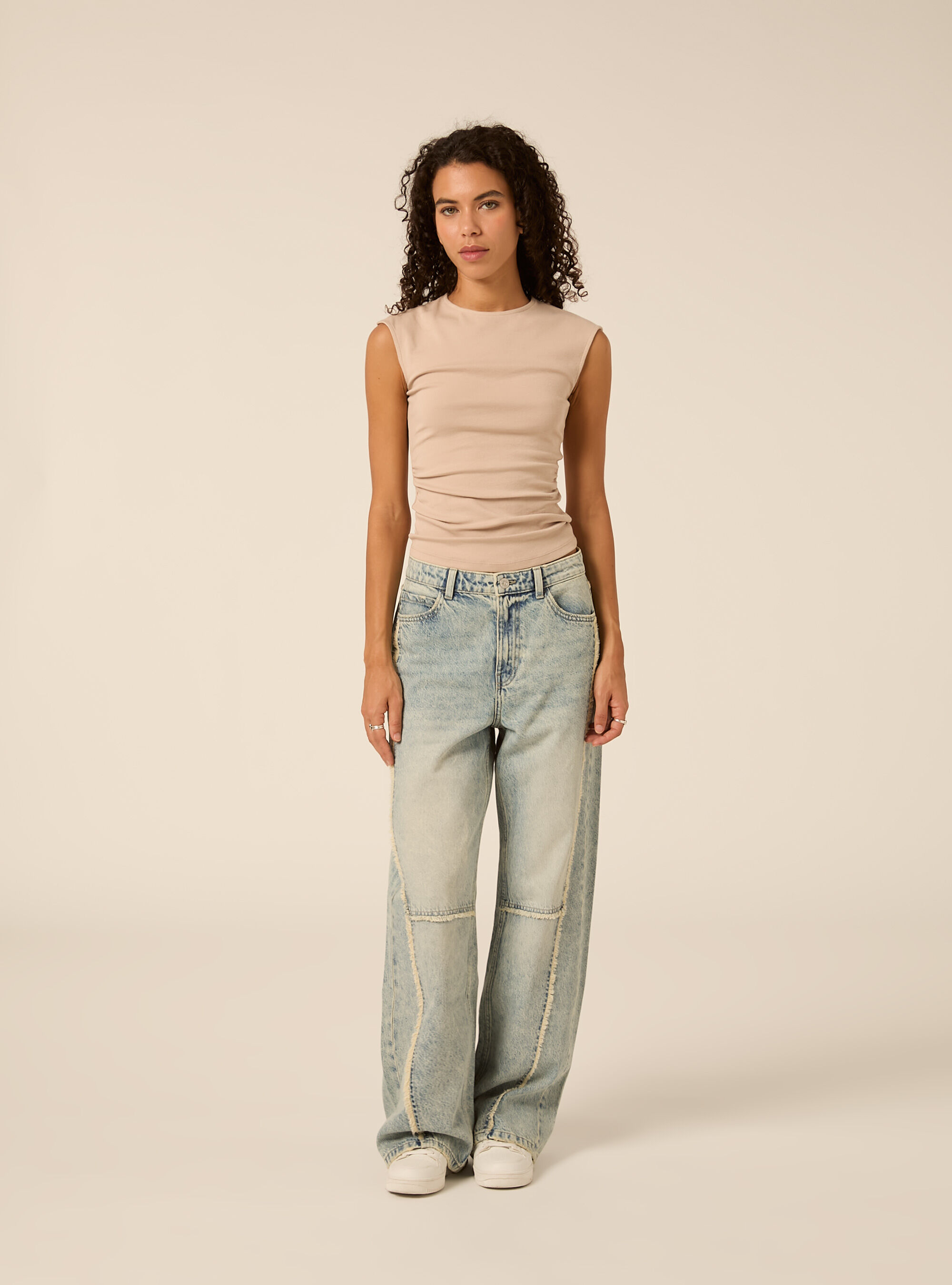 Wide leg baggy jeans with exposed seams and frayed details