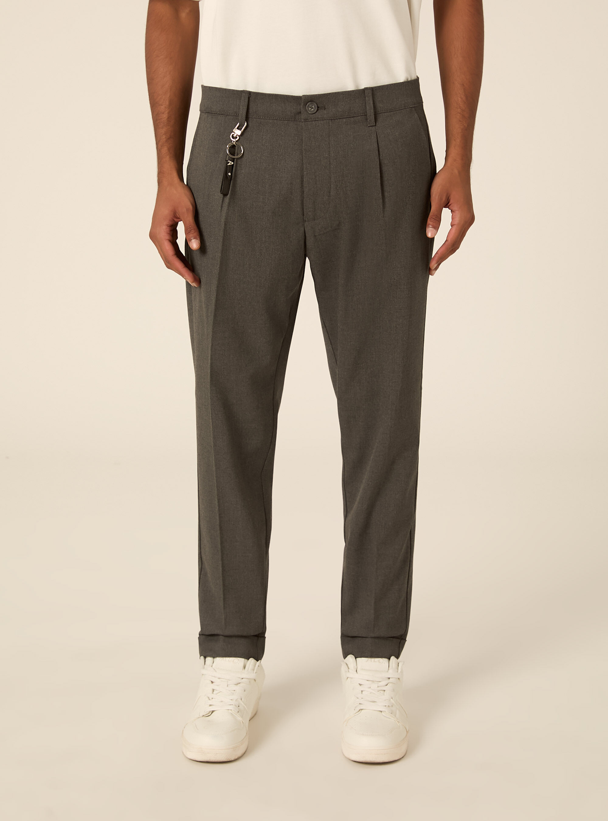 Tailored trousers with pleats and charm detail