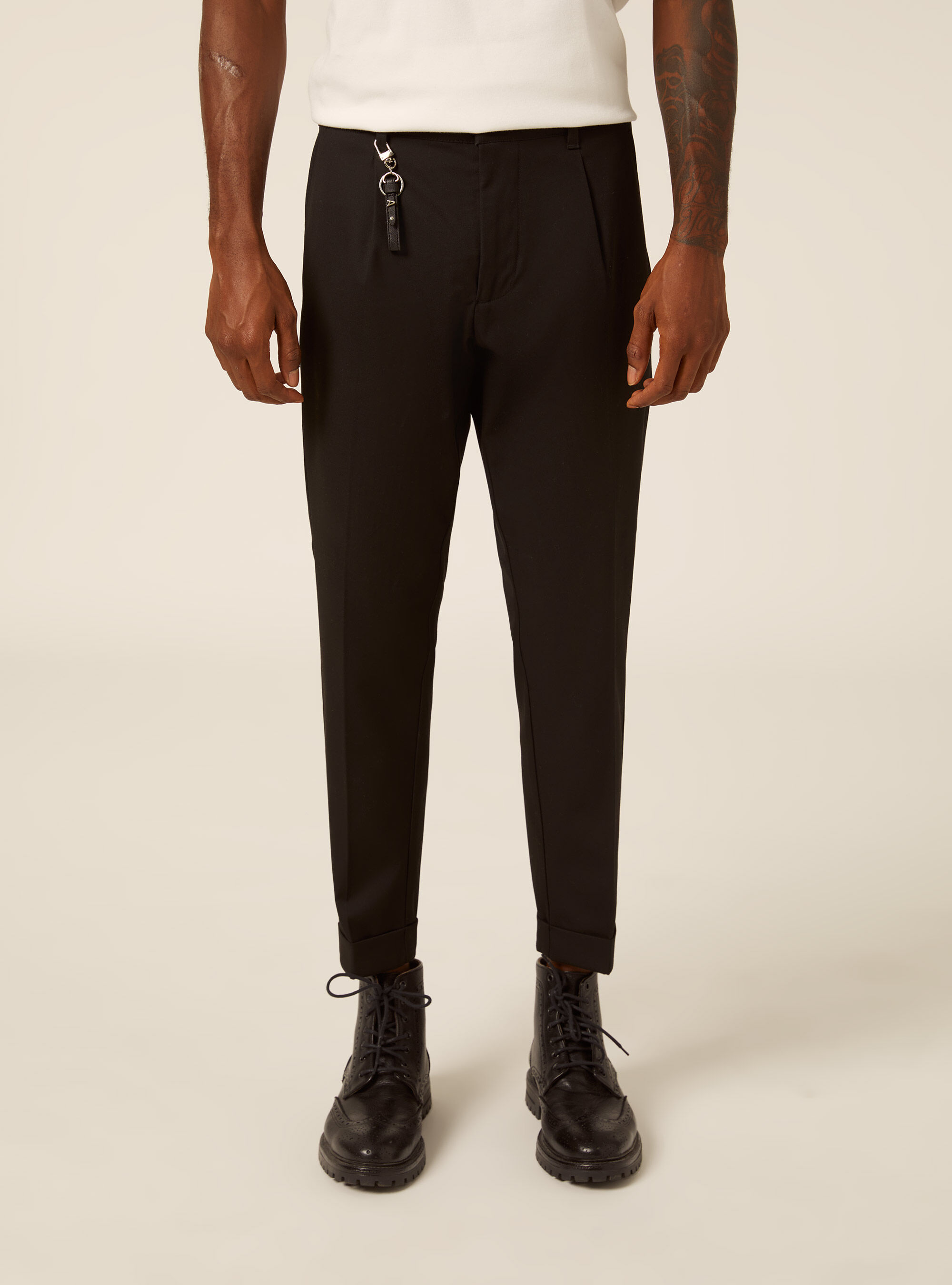 Tailored trousers with pleats and charm detail