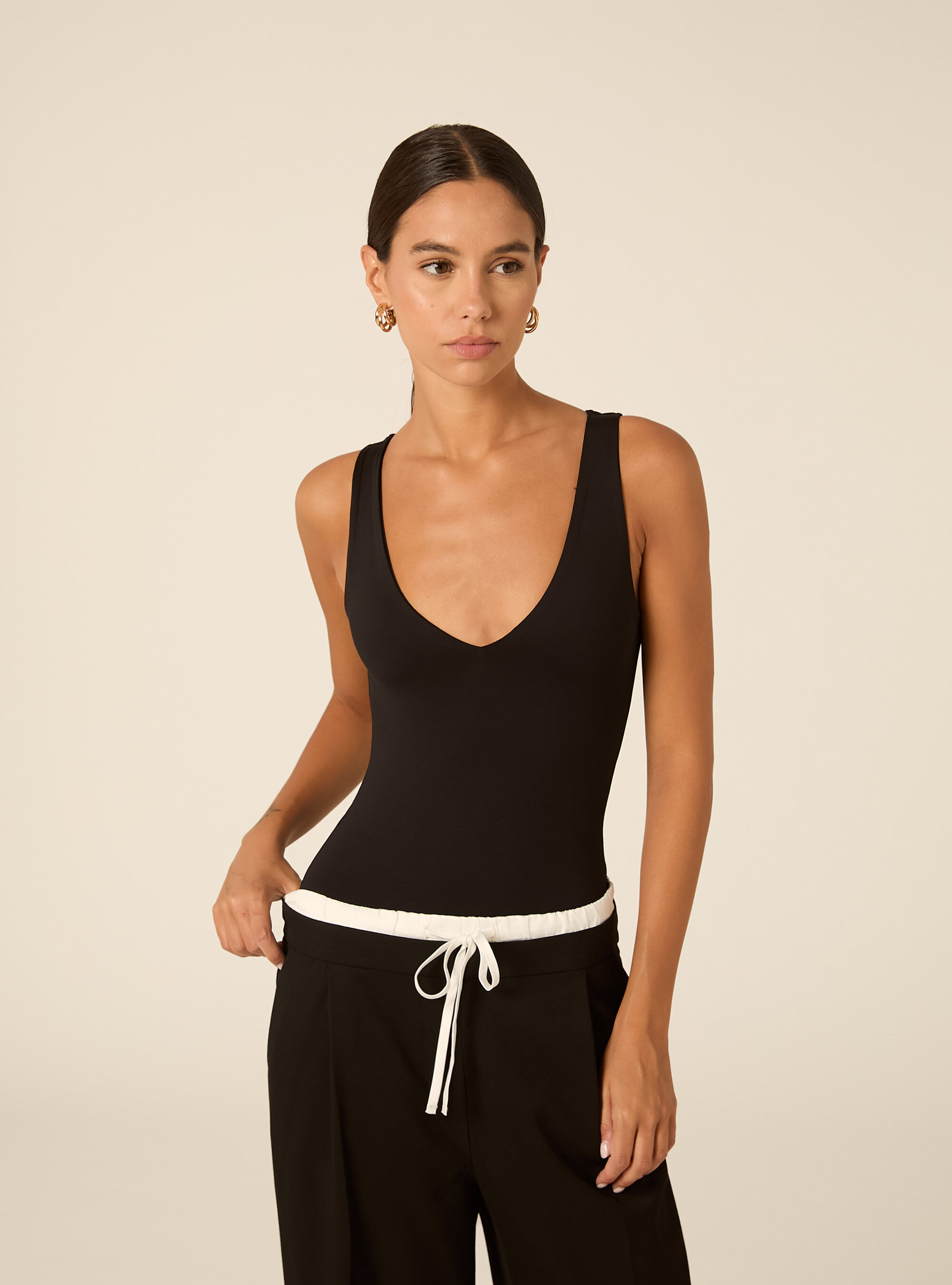 Sleeveless stretch fabric bodysuit with v neck
