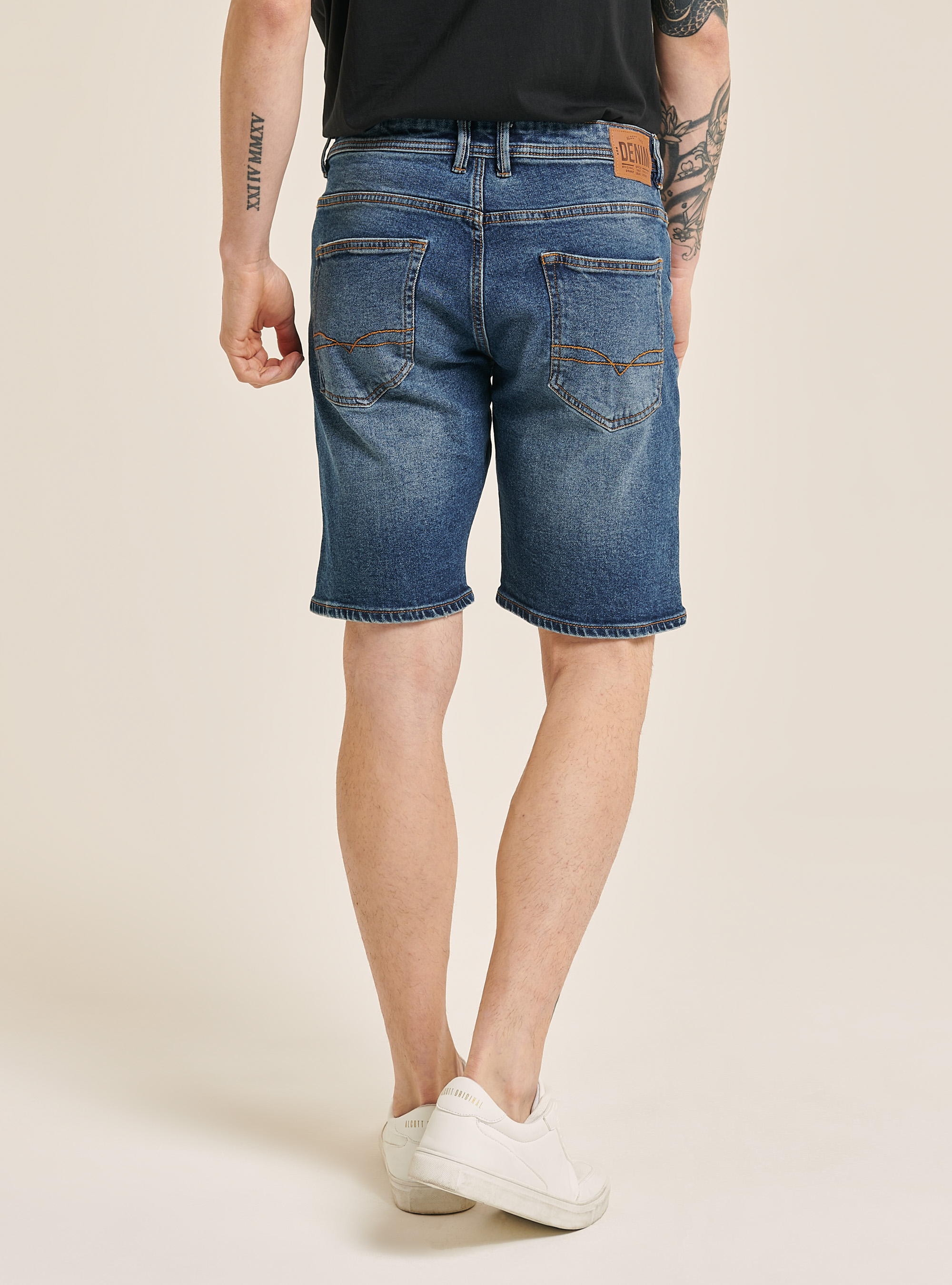 Stretch denim bermuda shorts with rips 
